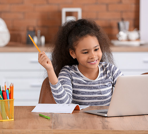 Girl doing homework with laptop