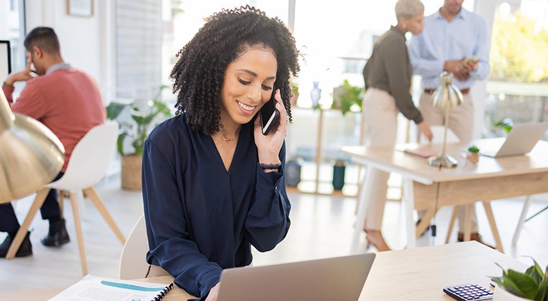 Woman talking on cell phone at office